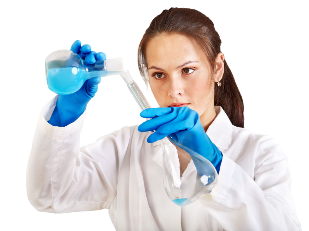 Woman with a brown ponytail in a lab coat pouring blue liquid from a beaker into a test tube.