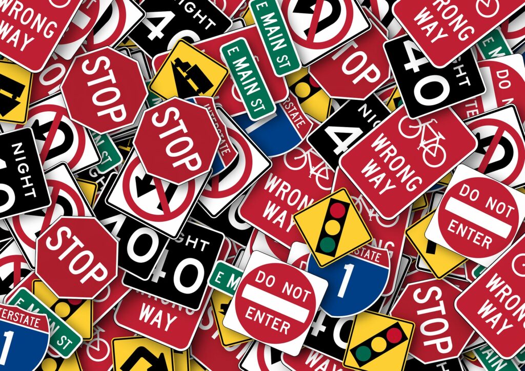 Many traffic signs piled onto each other